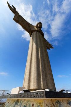 Lisbon, Portugal - May 11, 2024 : National Sanctuary of Christ the King statue in Lisbon, Portugal. It is located in Almada, and it overlooks Lisbon from one bank of the Tagus River.