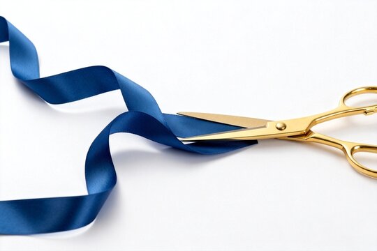 Gold scissors cutting blue ribbon
