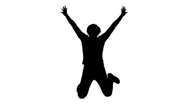 Silhouette of a happy person jumping with arms raised high