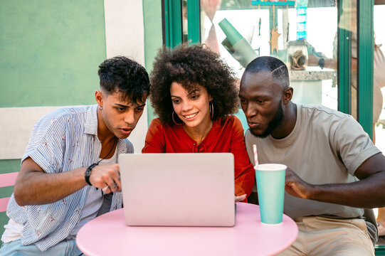 A group of multicultural university friends enjoys online shopping and fun moments together