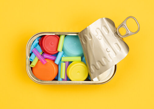 Plastic waste in an open tin. Canned food containing plastic concept