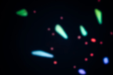 Fototapeta premium Defocussed colorful lights creating beautiful abstract lighting effect on dark background