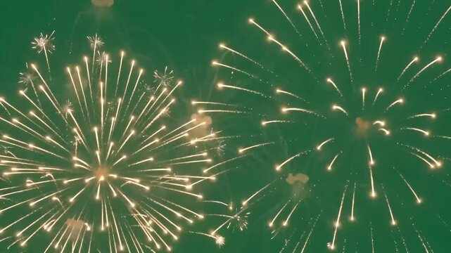 Golden sparks burst against a deep green sky