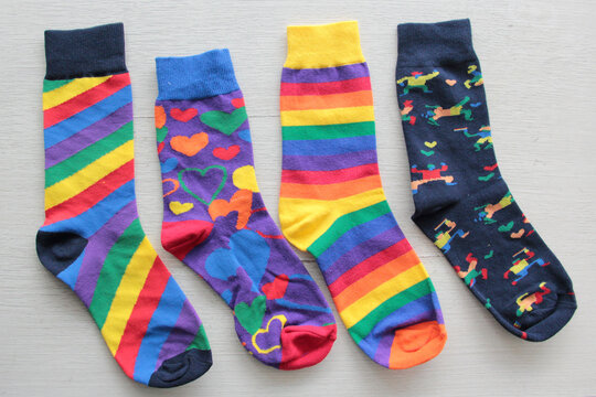 Colorful, mismatched socks ready to be worn as a symbol of inclusion, diversity, and acceptance to promote respect for people with Down syndrome