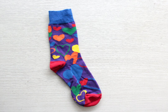 Colorful, mismatched socks ready to be worn as a symbol of inclusion, diversity, and acceptance to promote respect for people with Down syndrome