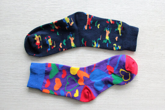 Colorful, mismatched socks ready to be worn as a symbol of inclusion, diversity, and acceptance to promote respect for people with Down syndrome