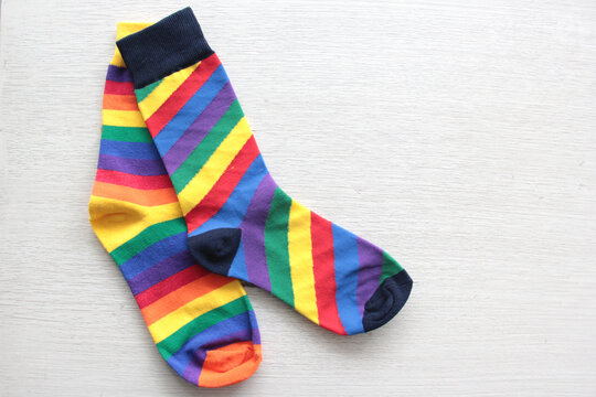 Colorful, mismatched socks ready to be worn as a symbol of inclusion, diversity, and acceptance to promote respect for people with Down syndrome