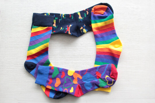 Colorful, mismatched socks ready to be worn as a symbol of inclusion, diversity, and acceptance to promote respect for people with Down syndrome