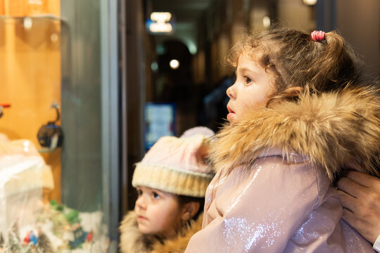 Children window shopping looking at christmas display