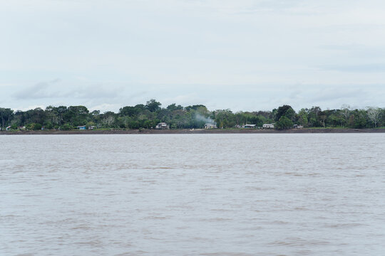 Isolated houses in the middle of the Amazon rainforest.