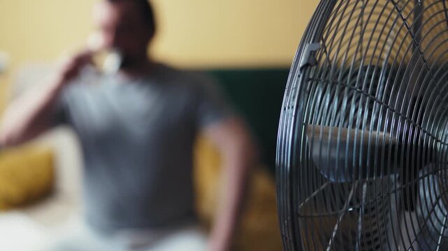 Man drinking cold fresh water from glass during heatwave