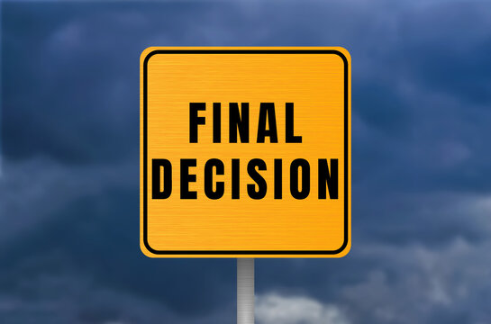 Final decision road sign standing on a pole against a dramatic, cloudy sky, symbolizing crucial choices and resolution