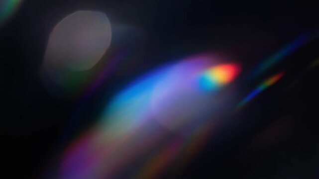 Glowing orb with colorful lens flares on black background