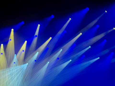 abstract background of colorful radiant blue and white stage lights