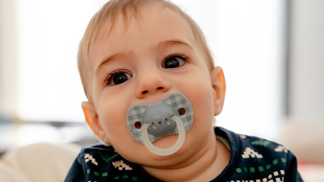 Adorable baby with pacifier close-up shot