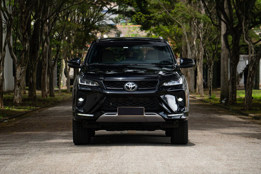 Black Toyota Hilux SW4 front full view, Luxury SUV outdoors on street lined with trees
