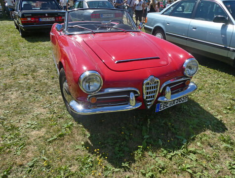 Garching near Munich, Germany - Old Timers Show: the sleek line of a red Alfa Romeo Giulietta spider, frontal view