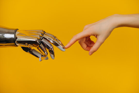 Human hand and a robot hand touching fingers, symbolizing interaction, collaboration, and the evolving relationship between humanity and advanced artificial intelligence and technological progress