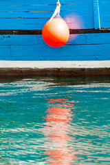 Orange fender against the blue hull of an old wooden boat - 5087 © Wolfgang Jargstorff