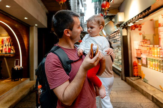 Father and child enjoying snack in Jiufen Old Street