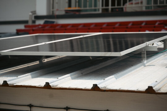 Solar Panels Mounted on Metal Roof with Aluminum Racking System for Renewable Energy Installation