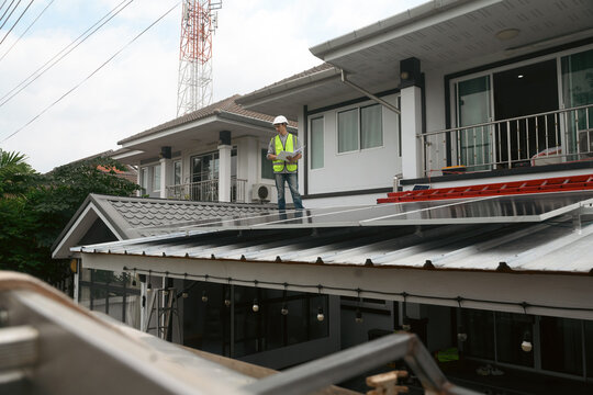 Engineer Inspecting Solar Panel Installation on Residential Home Rooftop