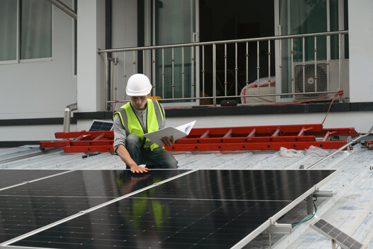 Engineer Inspecting Solar Panel Installation on Residential Rooftop with Clipboard and Safety Equipment