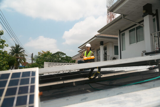 Solar Panel Installation Technician Working on Residential Rooftop with Toolkit and Safety Gear