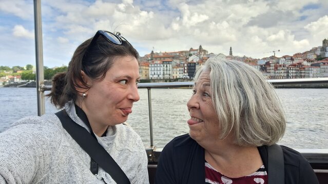 Funny picture of mother and daughter taking a selfie on vacation in porto, portugal