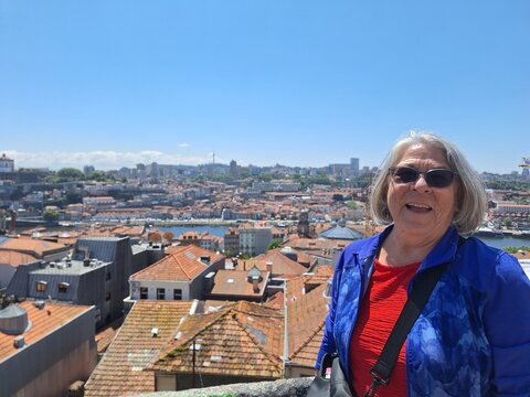 Retired woman taking a picture in porto, portugal