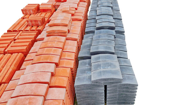 Stacked concrete curbstones on pallets.
