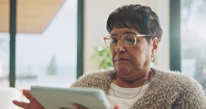 Senior, woman and scroll in home with tablet, glasses and search website for ebook on weekend break. Pensioner, person and internet in house with tech, reading news article and relax for retirement.