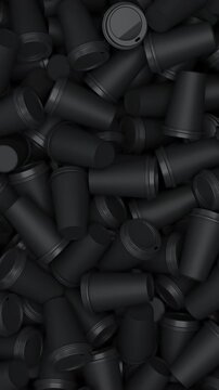 Camera pan over a pile of disposable cups in black for cafe packaging and takeaway beverage concept. Vertical video.