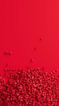 Close-up top view of rotating red polypropylene plastic granules and masterbatch resin pellet pile, 3D render seamless Vertical video.