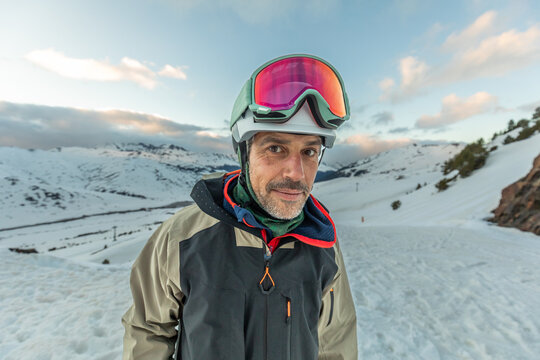 Skier in helmet and goggles enjoying a winter day