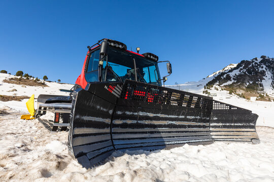 Snow grooming machine in Pyrenees winter landscape
