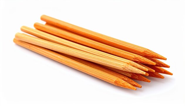 Manicure nail care sticks: A small bundle of natural wooden orange sticks for cuticle care, isolated on a clean white background.