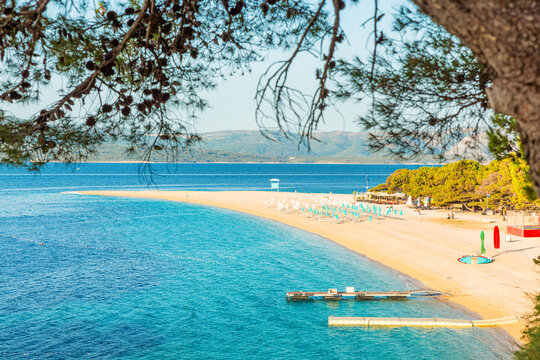 Zlatni Rat beach with crystal clear Adriatic Sea on Brac Island, Dalmatia, Croatia. Scenic coastal landscape, European travel destination, island tourism, boating lifestyle, relaxing summer vacation