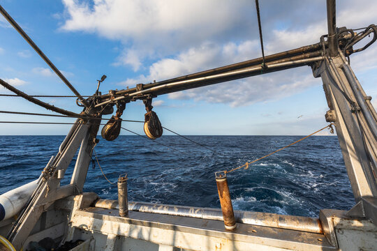 Fishing vessel rigging and winch over open ocean at sea