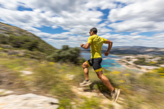Trail running along the sea with energetic motion