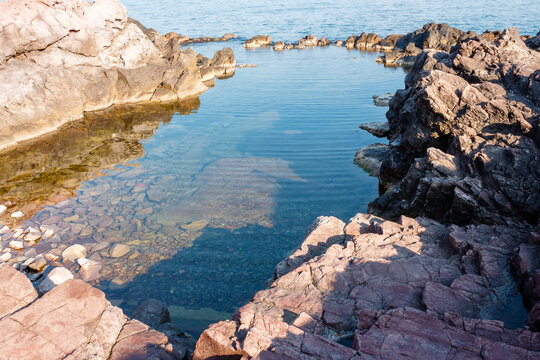 peaceful rock reflection in the sea water. calm summer vacation at the black sea. sunny weather