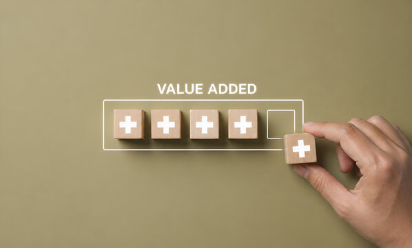 Value add concept. Hand place wooden cube with plus sign on light blue background. Positive thinking or personal growth and development. download style which means value added. value add for business.