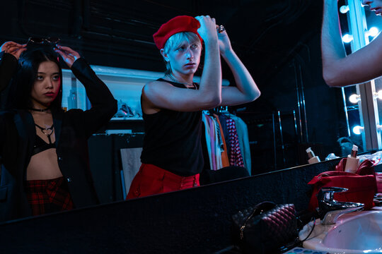 Actors preparing backstage in dressing room mirror light