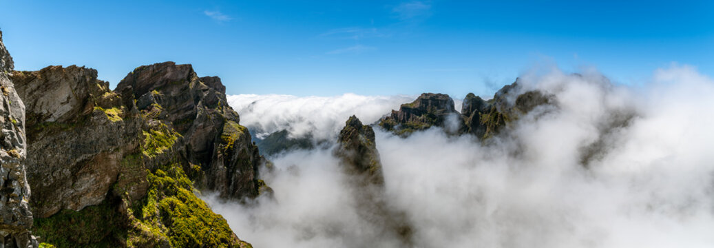 Jagged volcanic peaks above thick sea of clouds