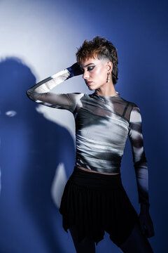 Young woman fashion model posing in dramatic studio light