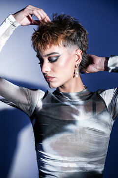 Young woman fashion model posing in studio with bold makeup