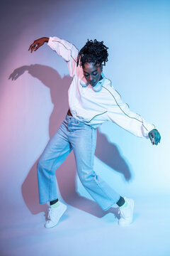 Afro woman dancer in studio with neon color lighting