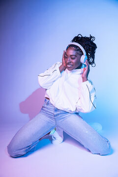 Afro woman dancer listening to music with headphones