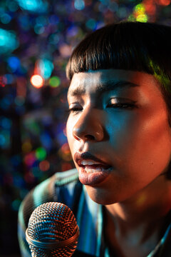 Close-up of Young Latin woman singer performing live