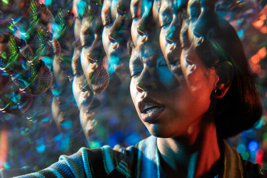Young Latin woman singer with kaleidoscopic lens effect